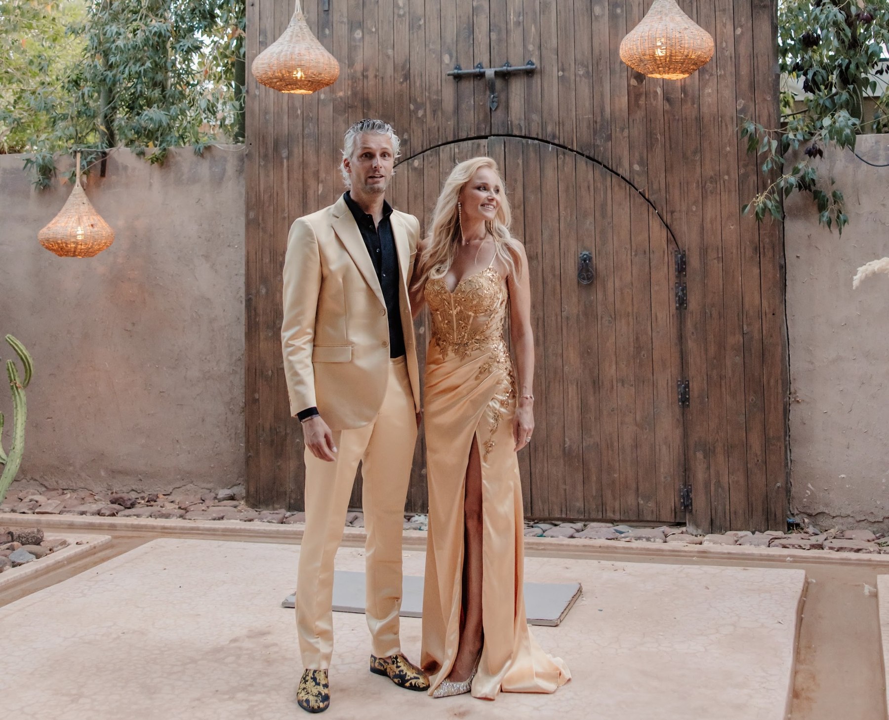 Wedding couple in front of a large wooden gate