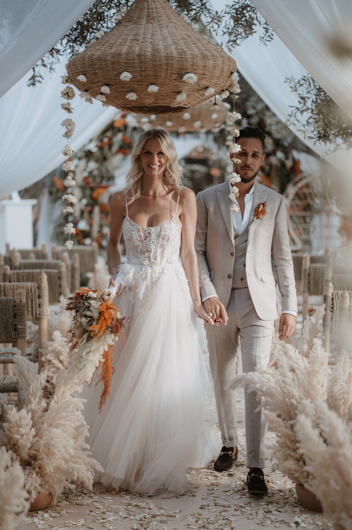 Couple walking through an outdoor ceremony in Marrakech